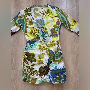 Green and blue paisley print dress, ruffled sleeves, and a bow tie in the front.